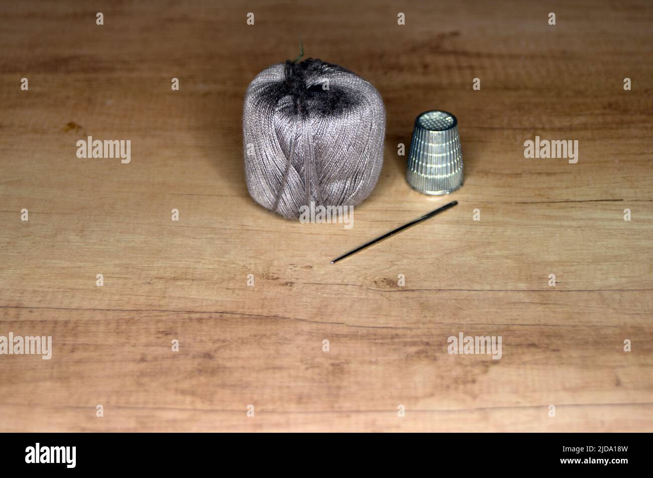 Housework, Hobby, Sewing needle, thread and thimble Stock Photo Alamy