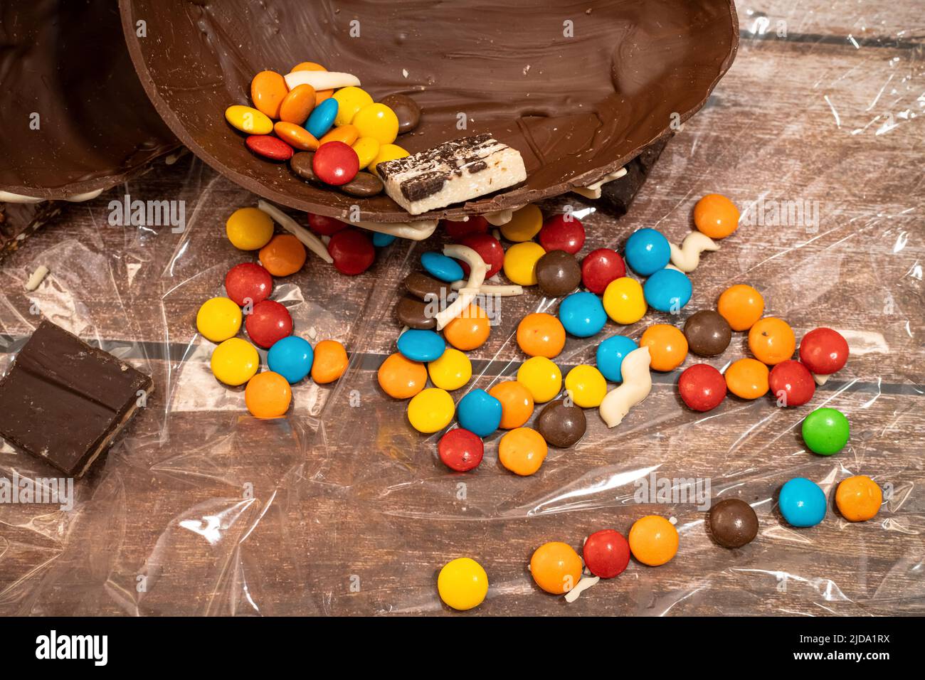 HALF AN EASTER EGG WITH COLORED CANDIES. Stock Photo
