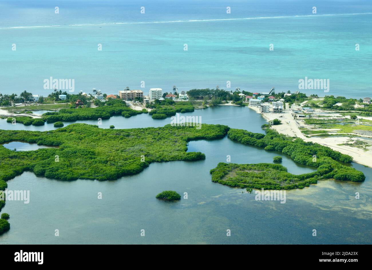 An aerial view of the southern part of Ambergris Caye, Belize. Some buildings can be seen as well as the lagoon. Stock Photo