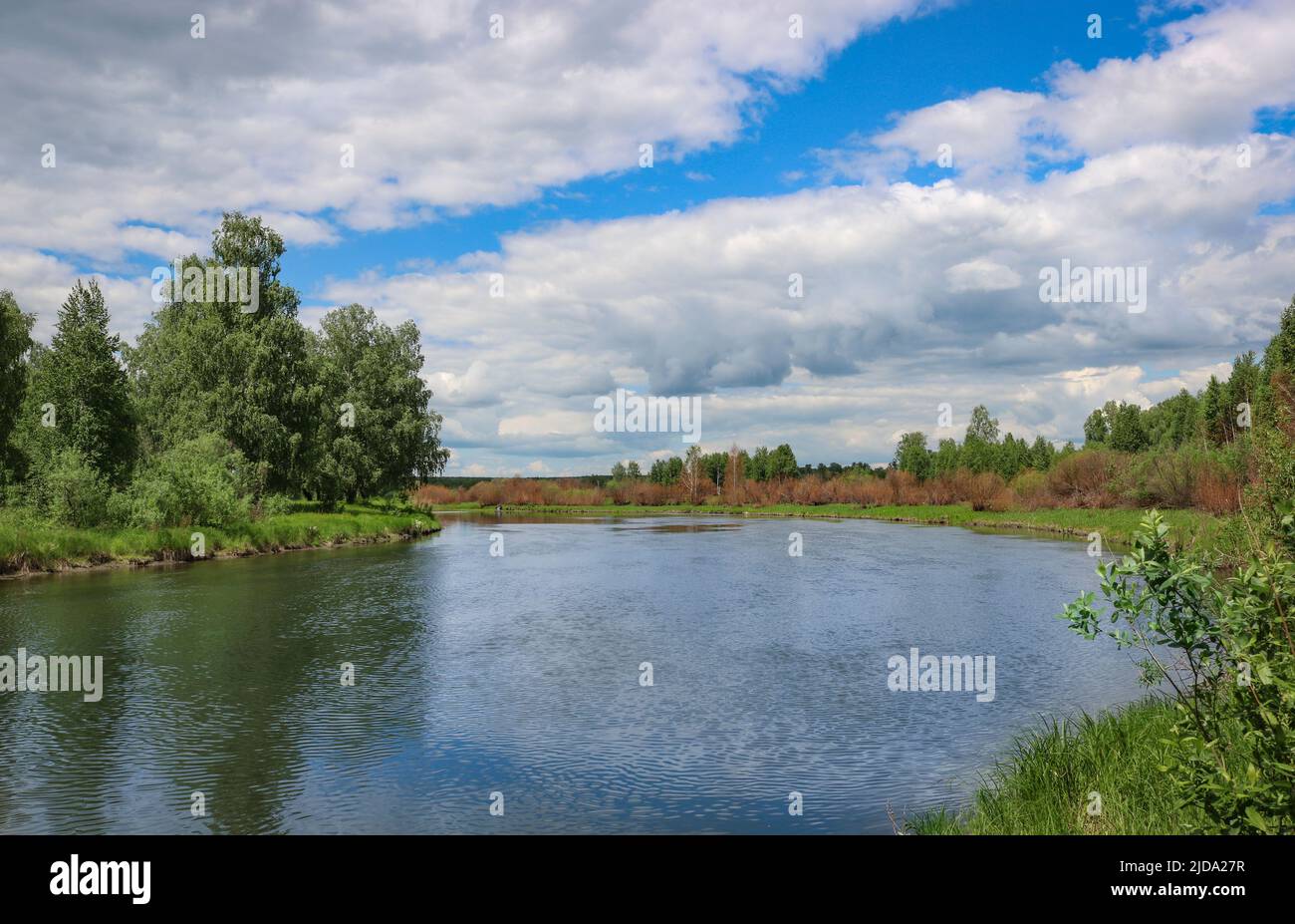 Summer landscape - flat river and blue sky with cirrus clouds. Stock Photo