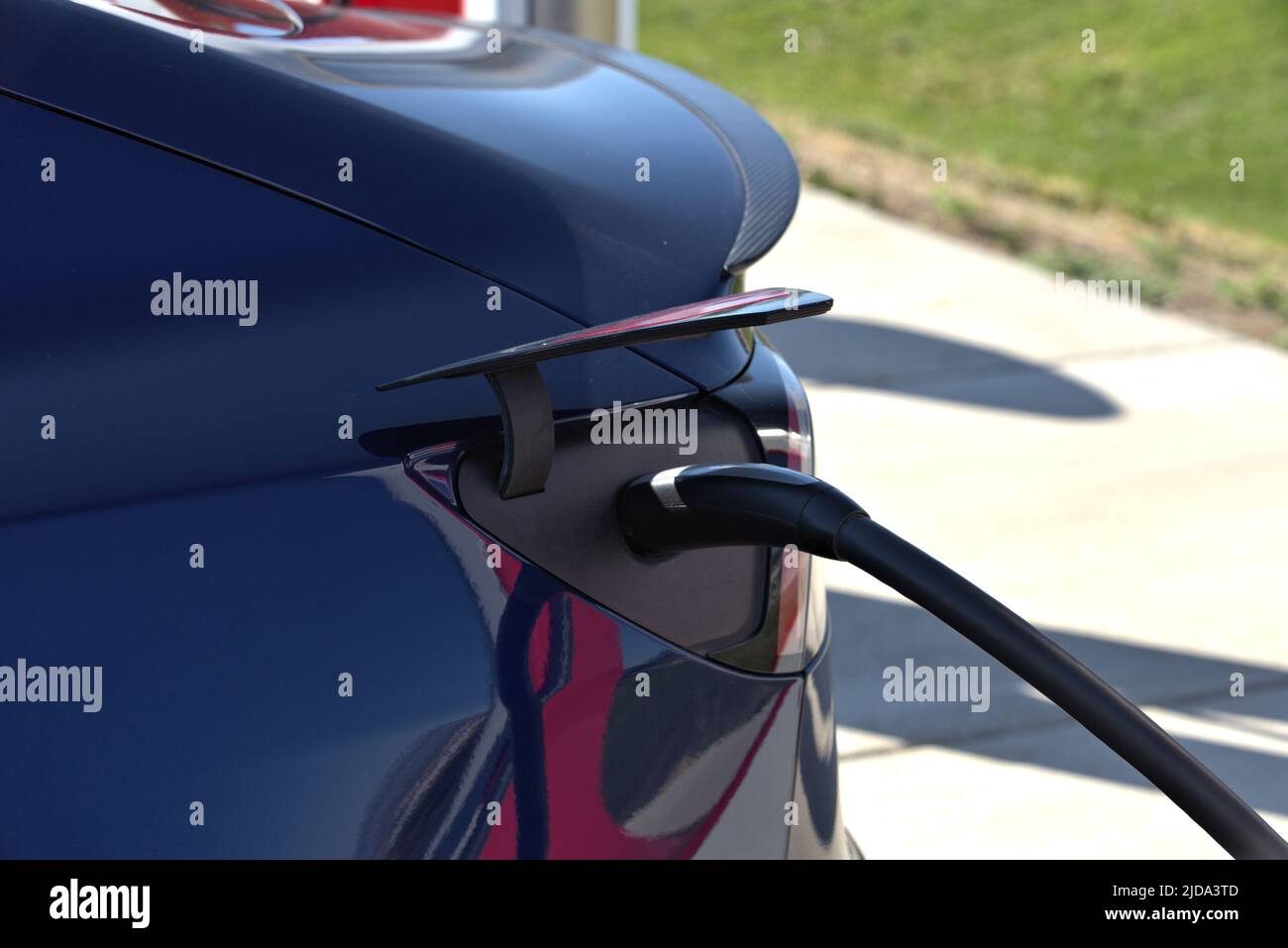 An electric car adds volts to the engine at an EV Charging station