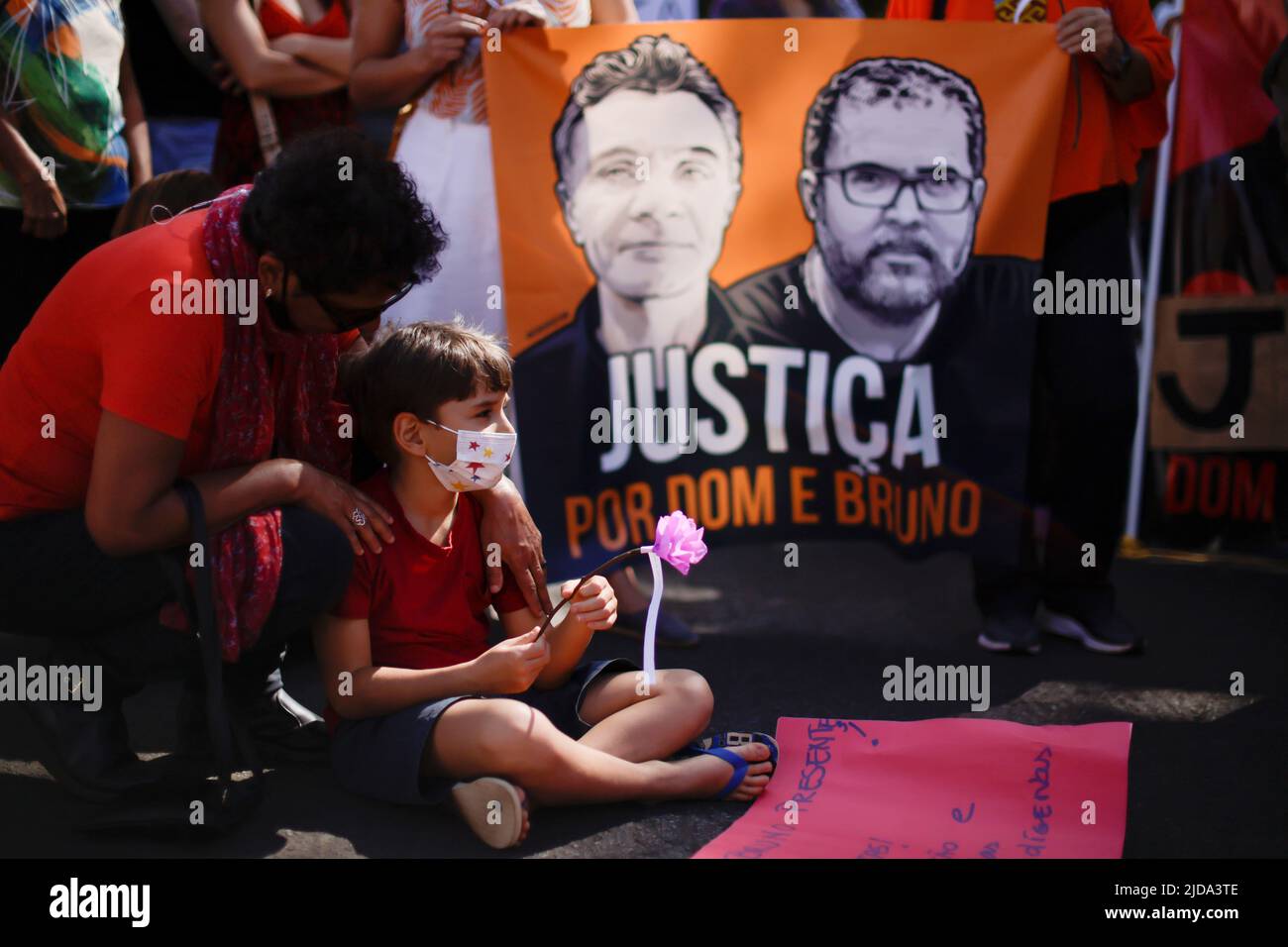 A child holds a flower, during a protest to demand justice for journalist Dom Phillips and indigenous expert Bruno Pereira, who were murdered in the Amazon, in Brasilia, Brazil June 19, 2022. REUTERS/Ueslei Marcelino Stock Photo