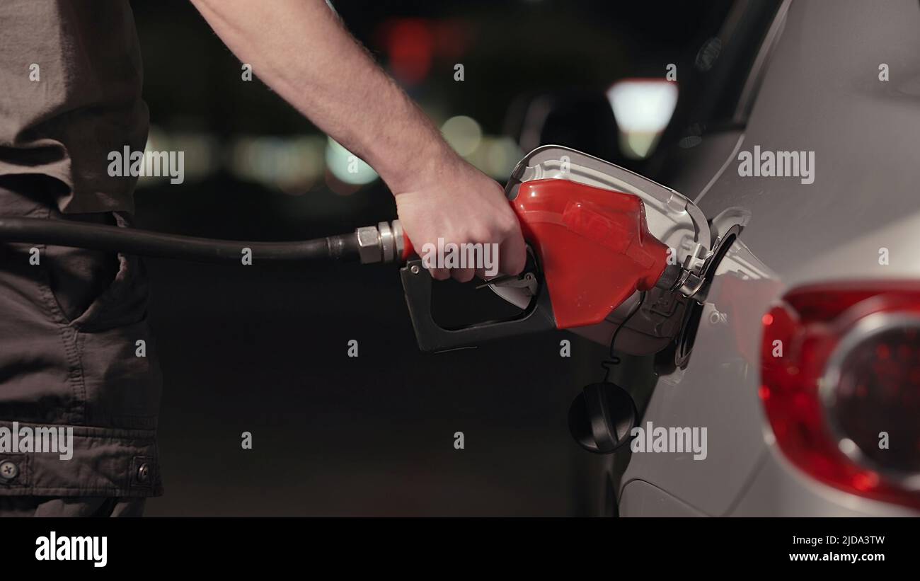 Fuel station nozzle filling car tank Stock Photo
