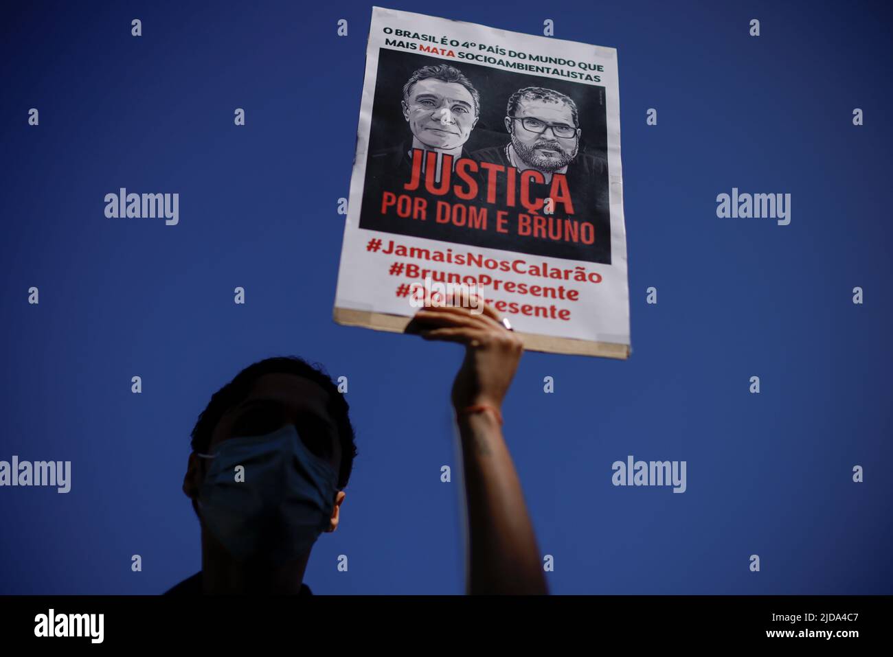 A demonstrator holds a sign during a protest, to demand justice for journalist Dom Phillips and indigenous expert Bruno Pereira, who were murdered in the Amazon, in Brasilia, Brazil June 19, 2022. REUTERS/Ueslei Marcelino Stock Photo