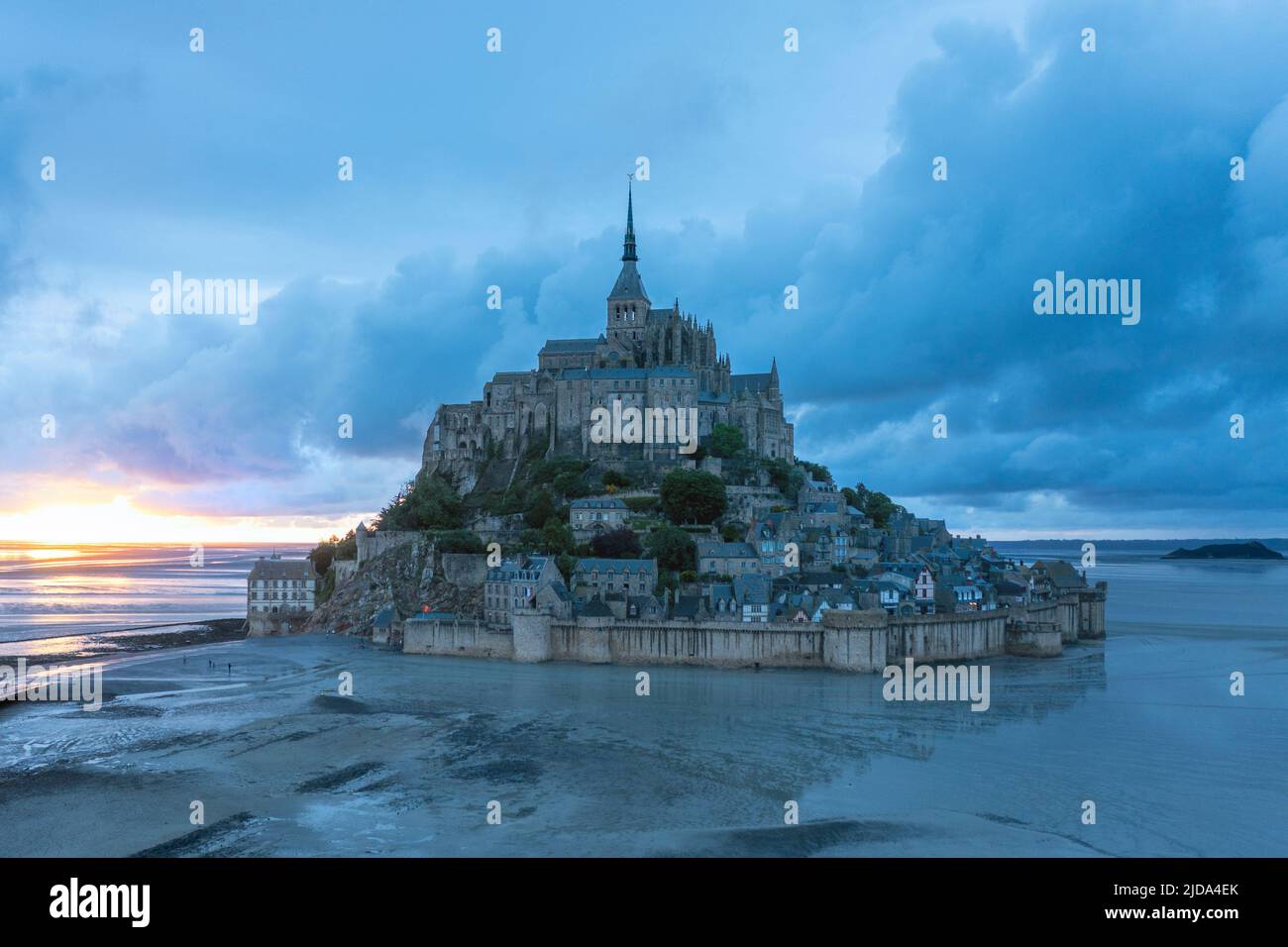 Sunset view of Le Mont Saint Michel (Saint Michael's Mount), a small, rocky tidal island, famous for its medieval abbey, Normandy, France. Stock Photo