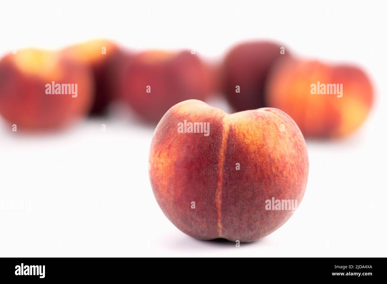 Fresh peaches on bright background. Selective focus. Stock Photo
