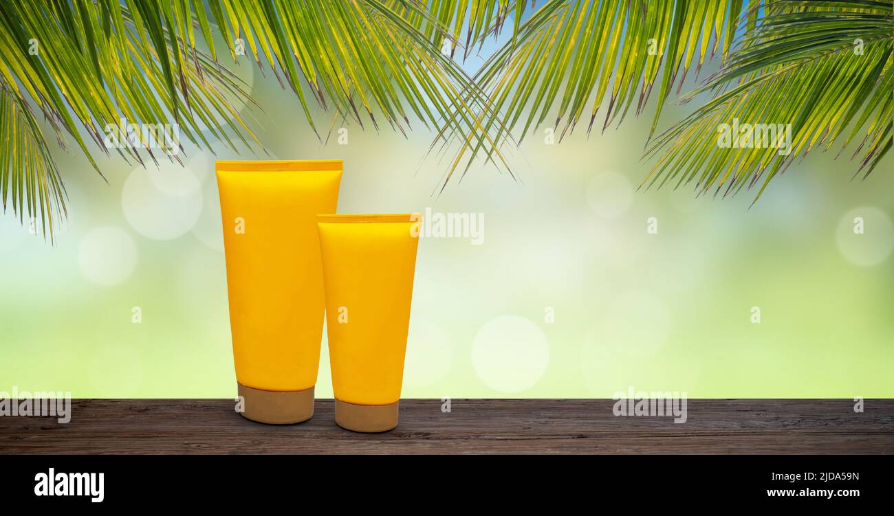 Tropical skin care product mock-up with palm branches. Stock Photo