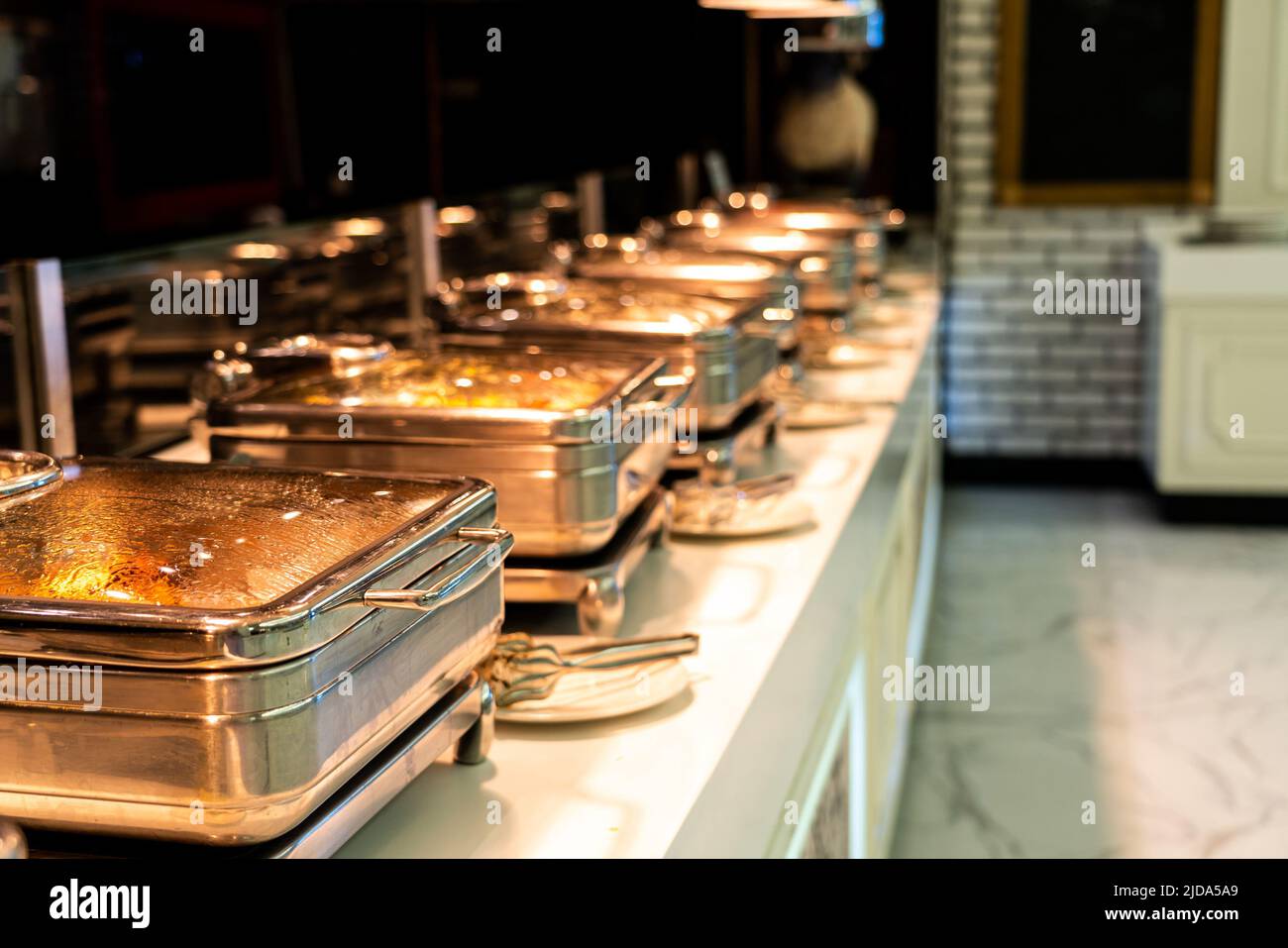Many buffet heated trays ready for service in hotel restaurant Stock