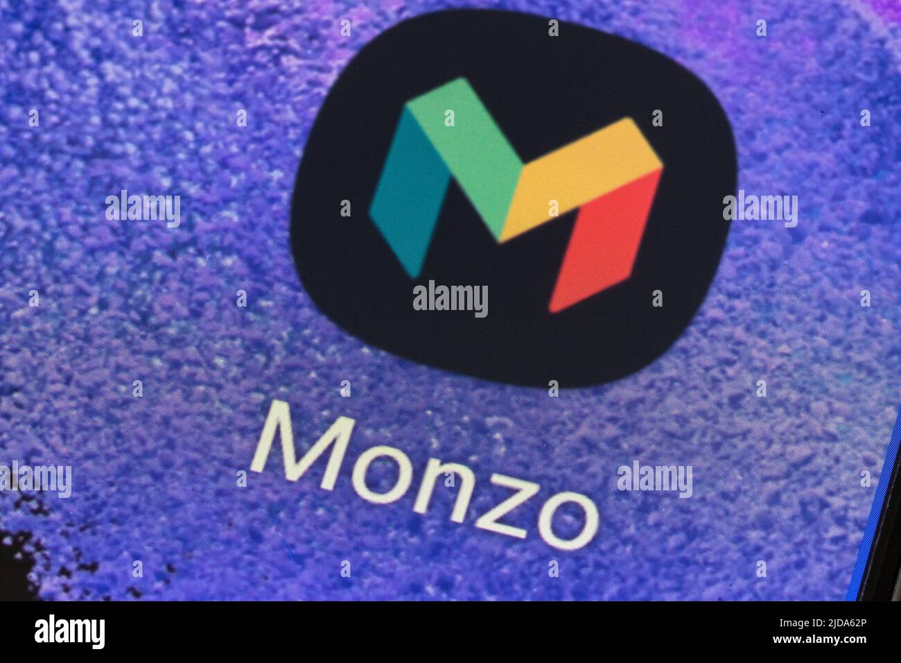 Closeup of the Monzo App logo and icon on a mobile phone screen. Monzo was one of the earliest of the online only app-based UK challenger banks Stock Photo