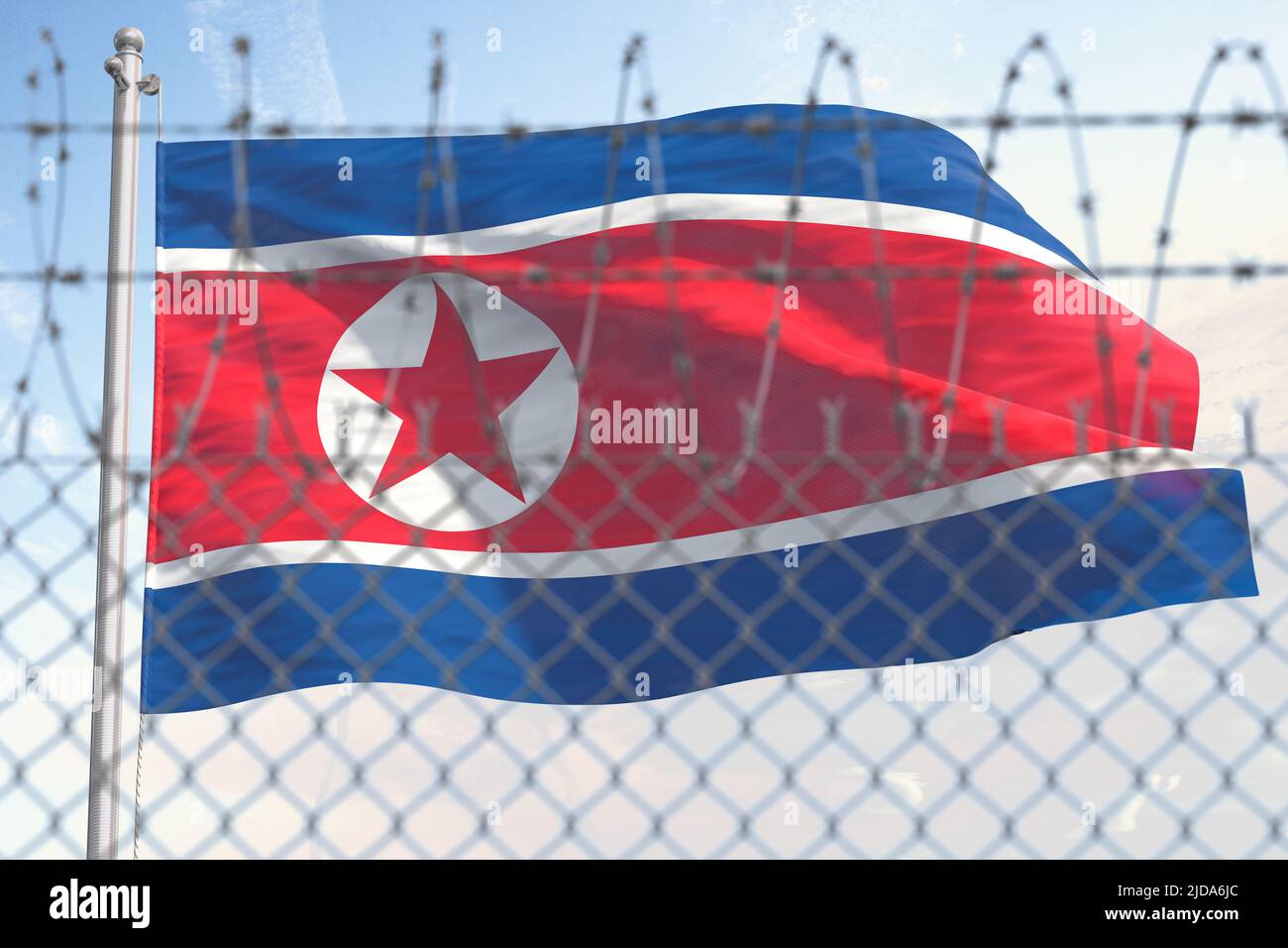 Flag of Nothern Korea behind barbed wire fence. Concept of sanctions, embargo, dictatorship, discrimination and violation of human rights and freedom Stock Photo