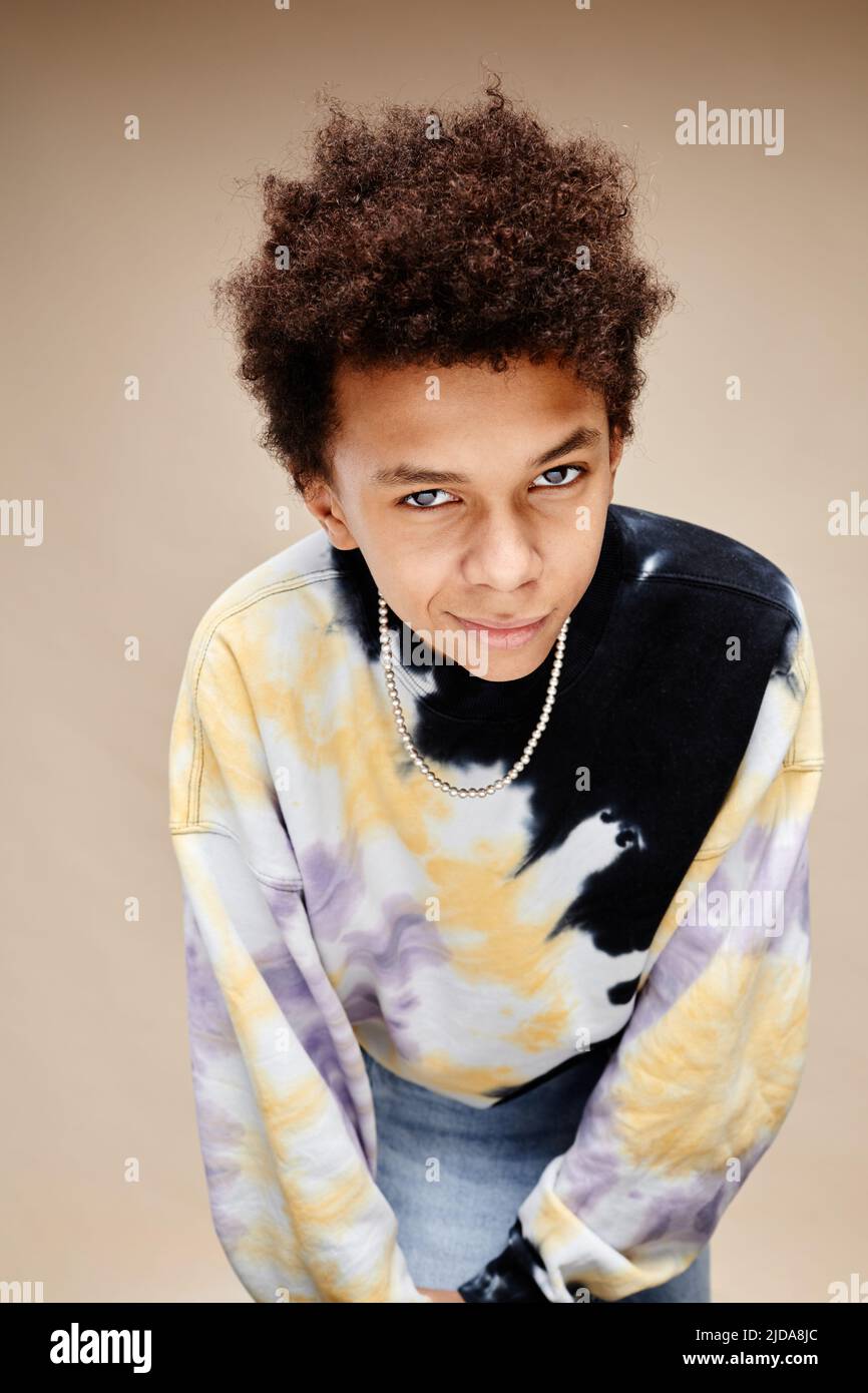 Vertical portrait of African American teenage boy wearing tie dye shirt
