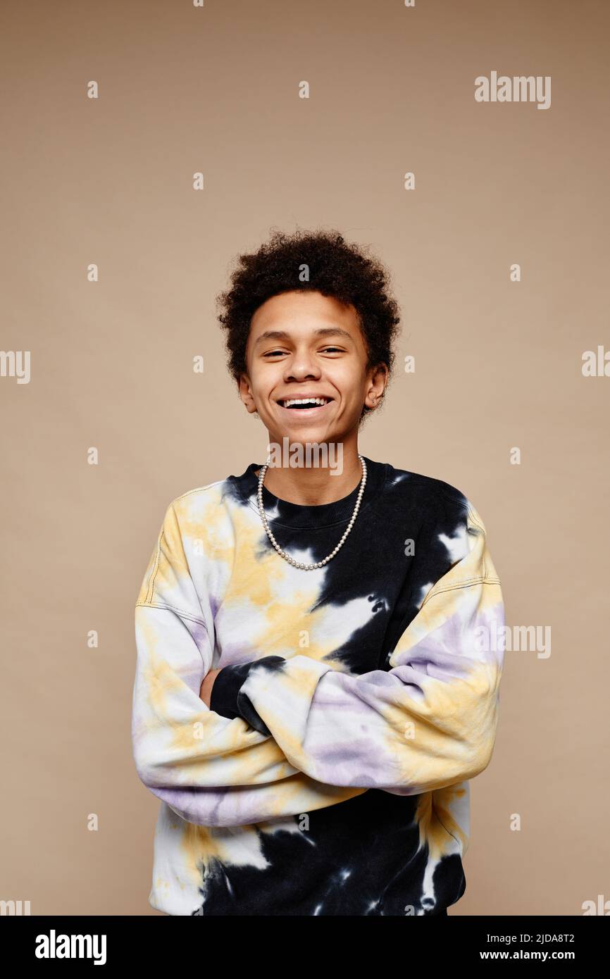Vertical portrait of African American teenage boy wearing tie dye shirt