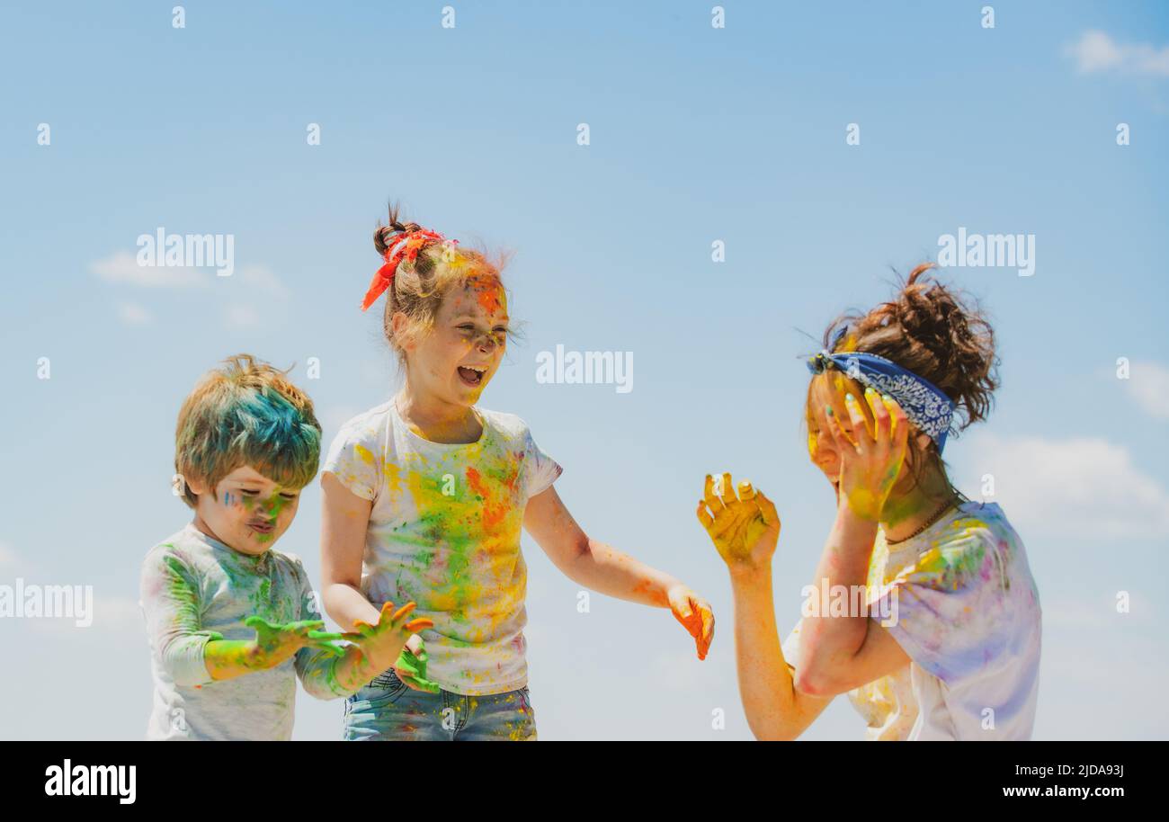 Portrait of a cute kids painted in the colors of Holi festival. Stock Photo