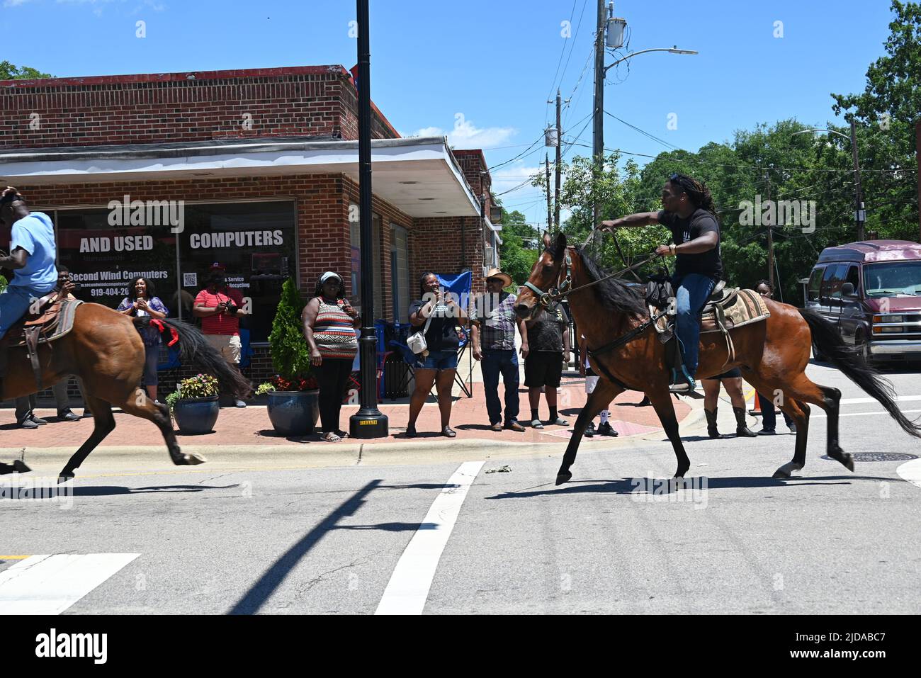 African American cowboys parade on horseback through Zebulon, NC, as