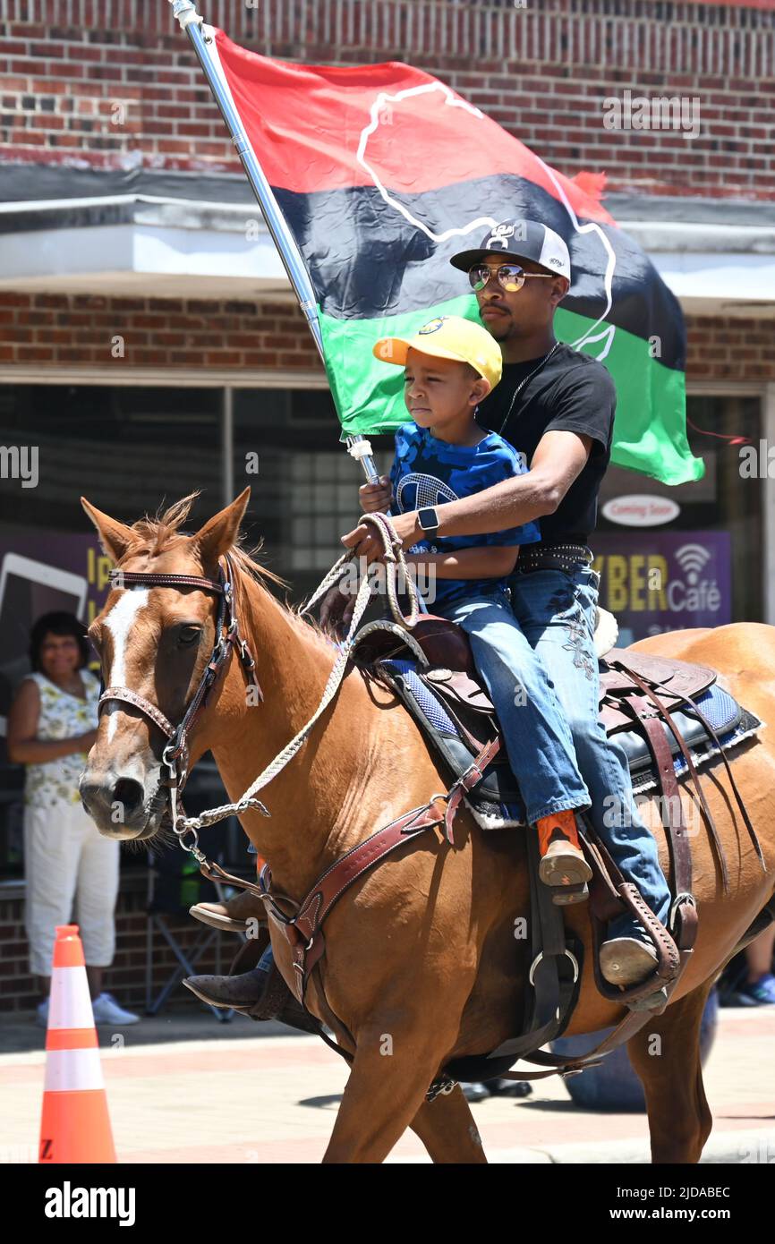 African American cowboys parade on horseback through Zebulon, NC, as
