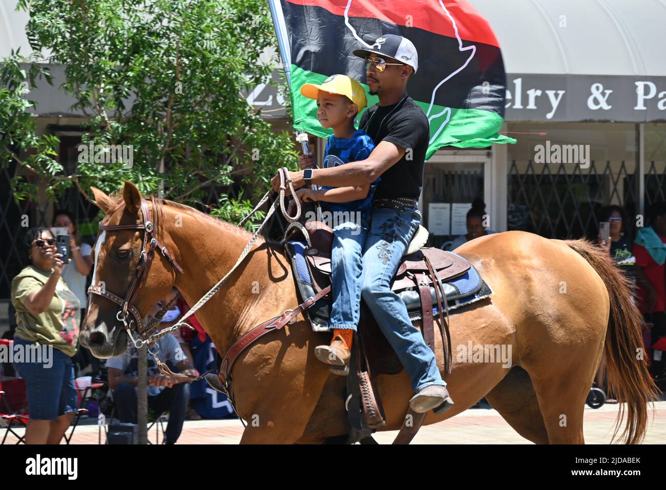 African American cowboys parade on horseback through Zebulon, NC, as