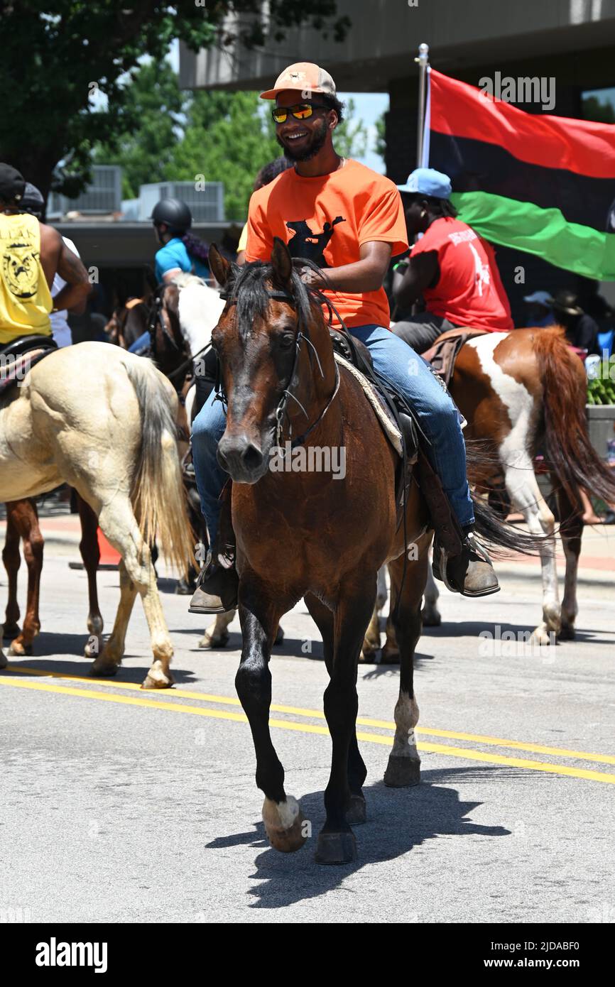 African American cowboys parade on horseback through Zebulon, NC, as
