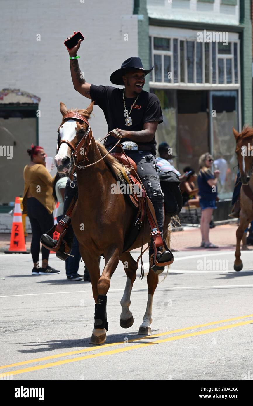 African American cowboys parade on horseback through Zebulon, NC, as