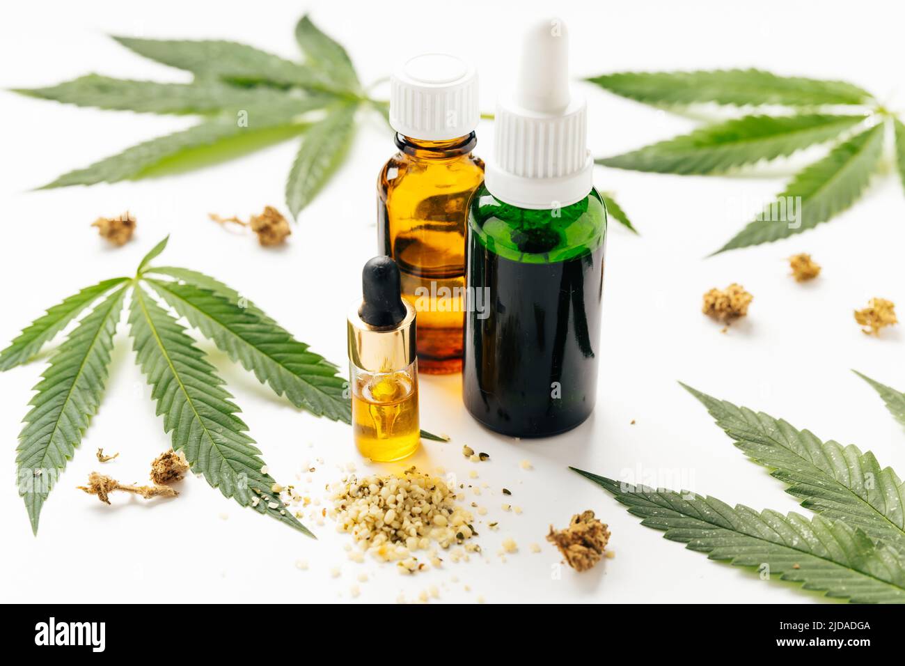 Cannabis oil, hemp leaves, dry flowers on white background. Natural cosmetics. Omega fats. Increasingly legal and medical use of marijuana Stock Photo