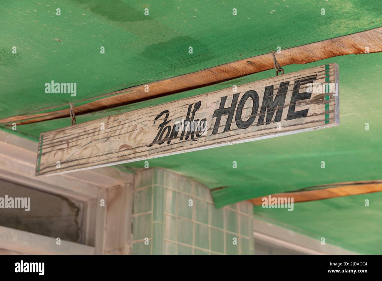 Old store sign on an abandoned building, For the Home, green roof and Stock Photo