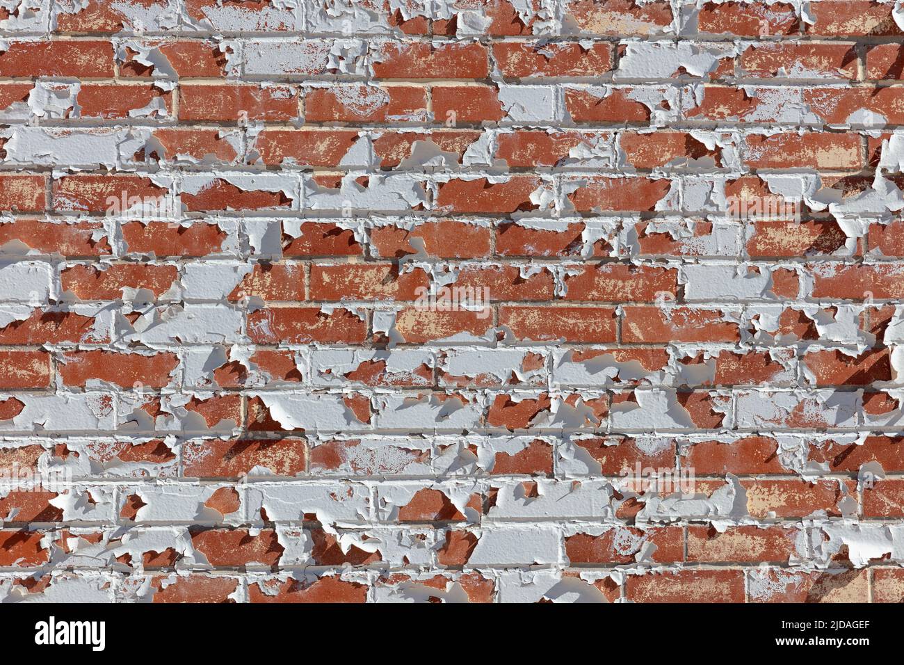 Peeling paint on old brick wall. Stock Photo