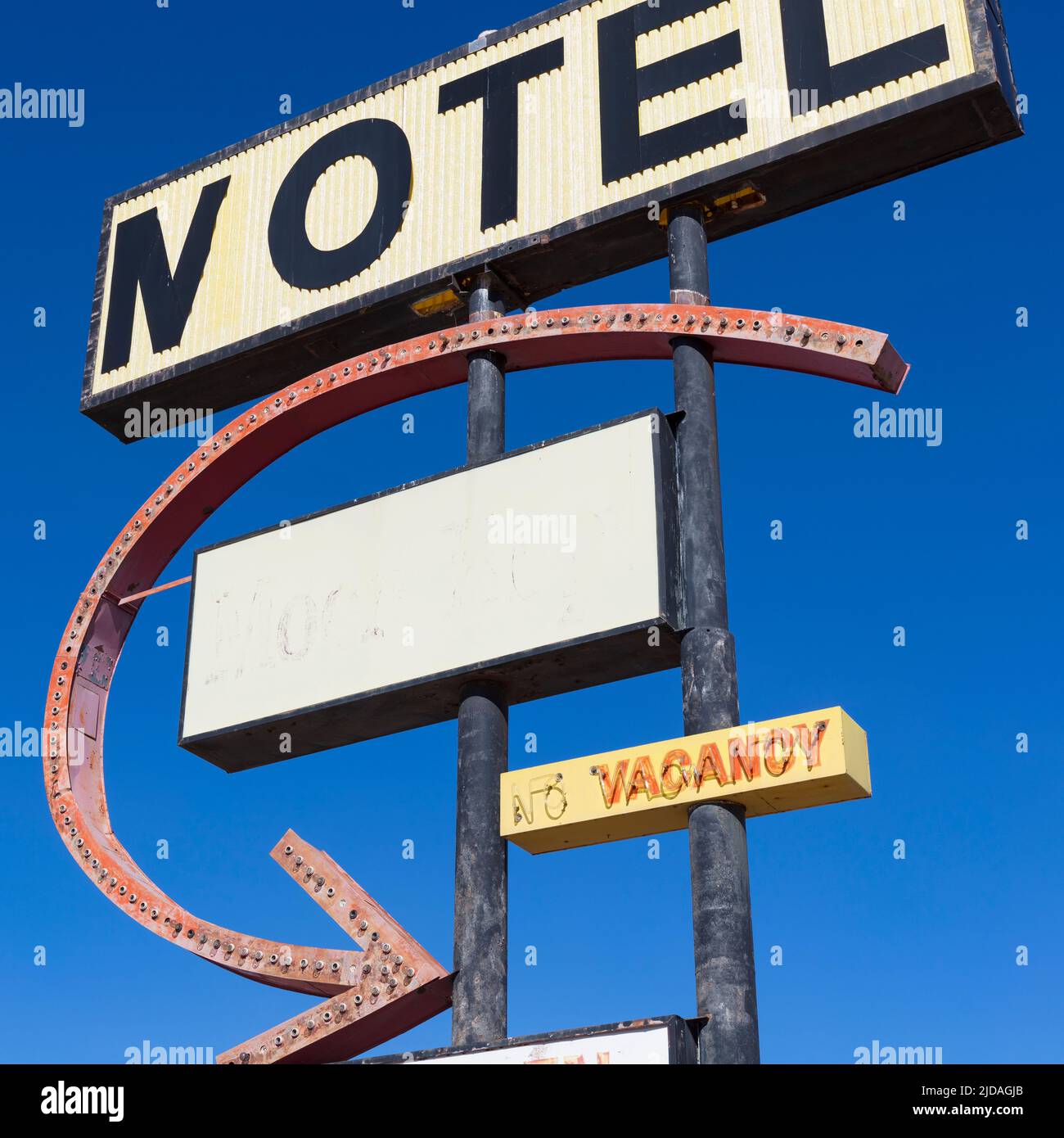 Old rusting Motel sign by the roadside. Stock Photo