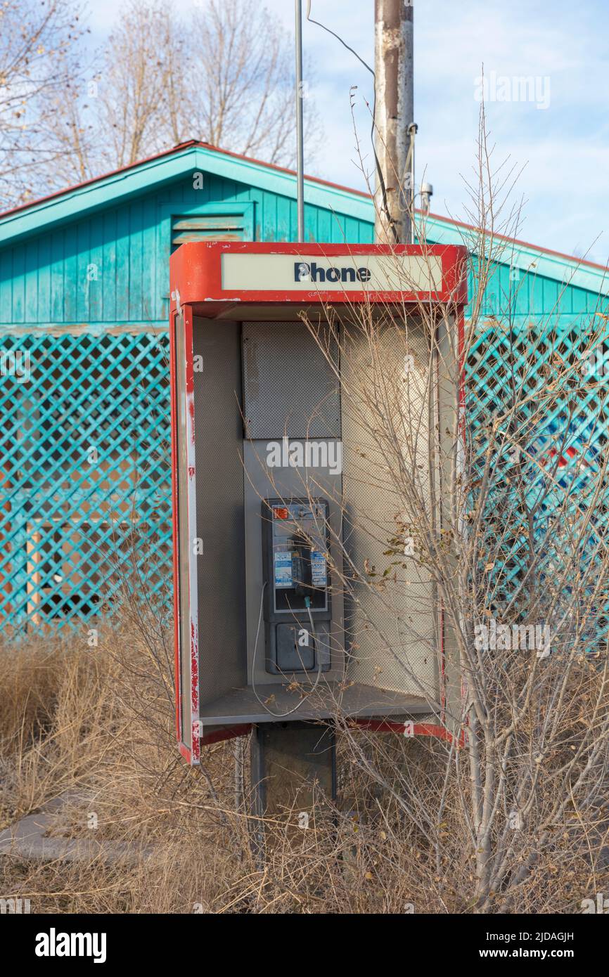 Abandoned old phone booth and deserted store by the roadside. Stock Photo
