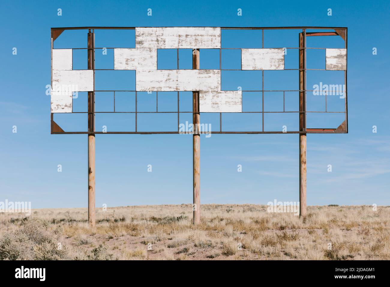 An old billboard, empty panels, in the middle of desert scrub. Stock Photo