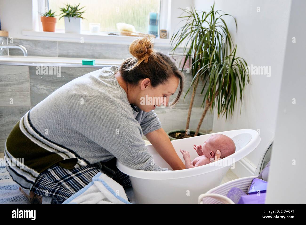 Mother bathing 3 month old baby boy in bathroom Stock Photo Alamy