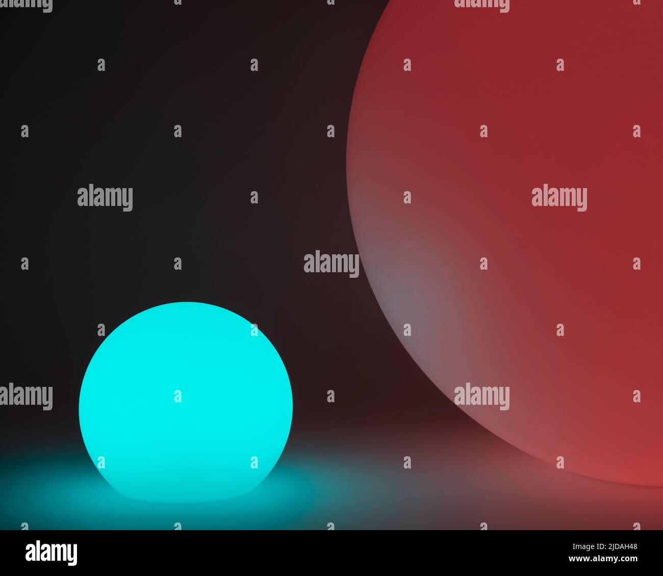 Glowing and illuminated spherical coloured orbs on a black background. Stock Photo