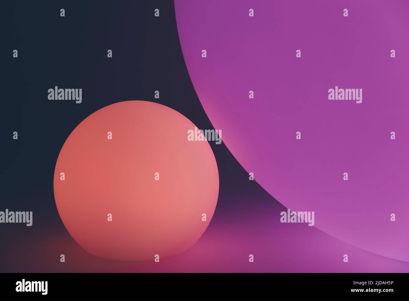 Glowing and illuminated spherical coloured orbs on a black background. Stock Photo