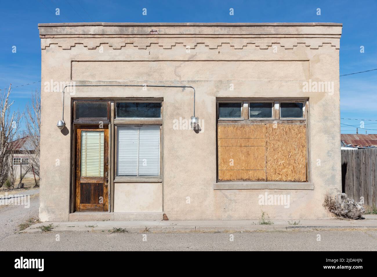 Abandoned building facade, boarded up windows and stonework pattern. Stock Photo