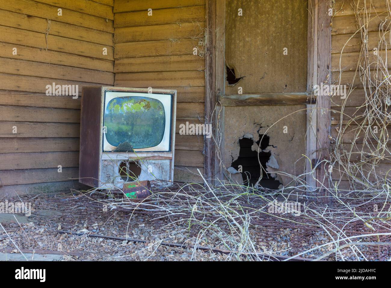 Old TV set on front porch of an abandoned homestead. Stock Photo