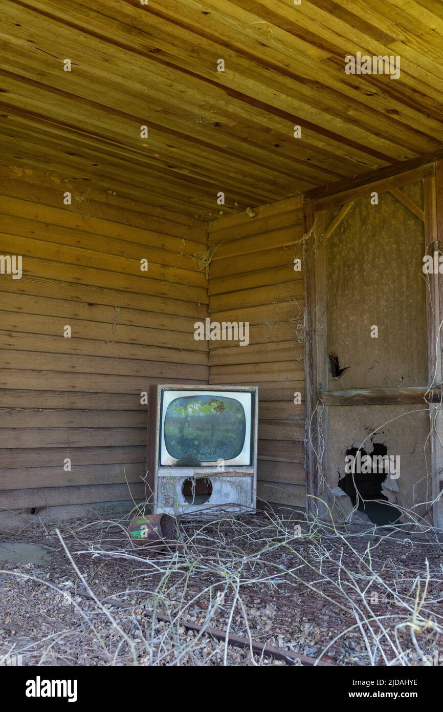 Old TV set on front porch of an abandoned homestead. Stock Photo