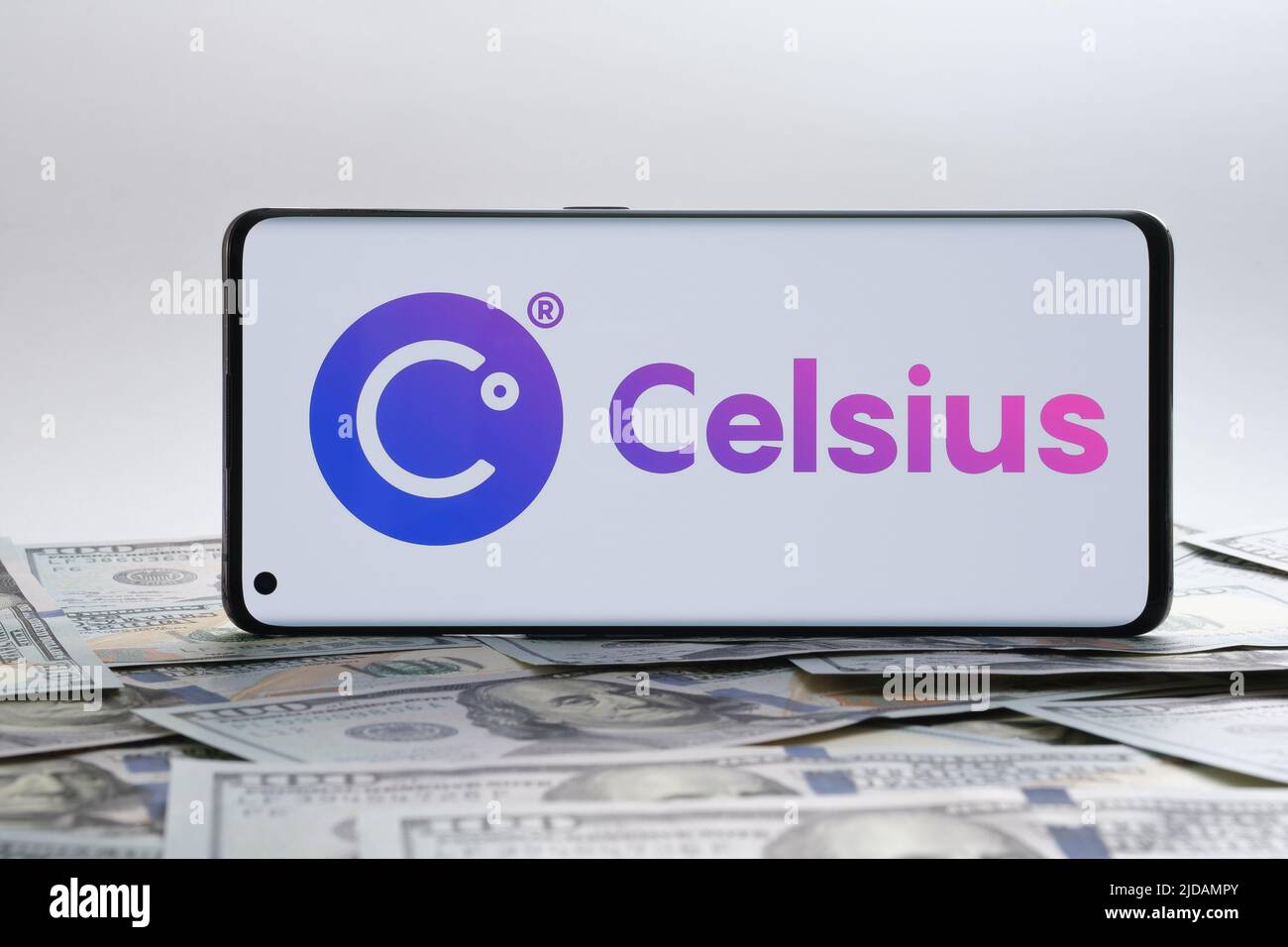 Celsius crypto company logo seen on smartphone placed on the dollar banknotes. Stafford, United Kingdom, July 19, 2022 Stock Photo