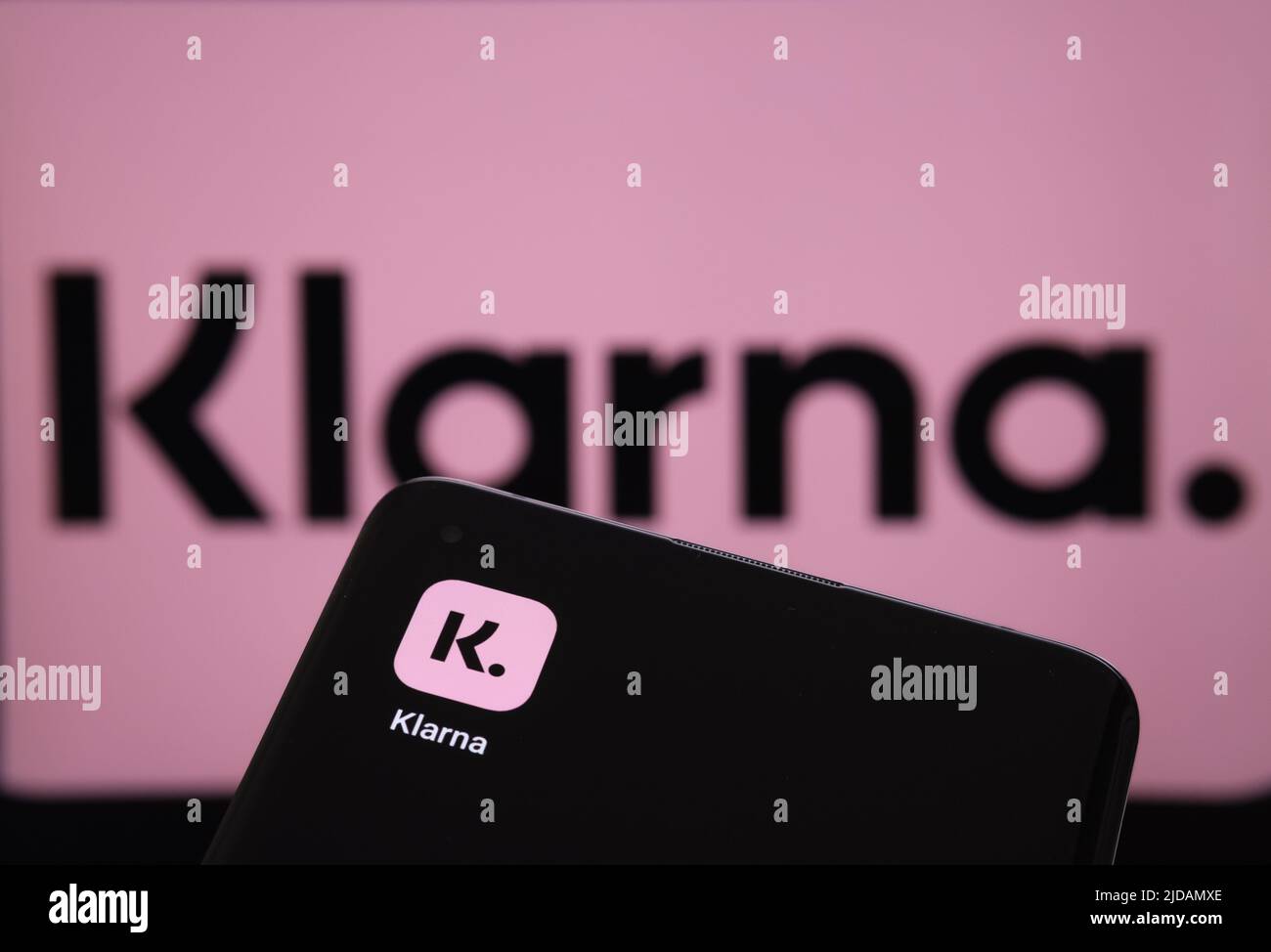Klarna app seen on the screen of smartphone and Klarna logo on the ...