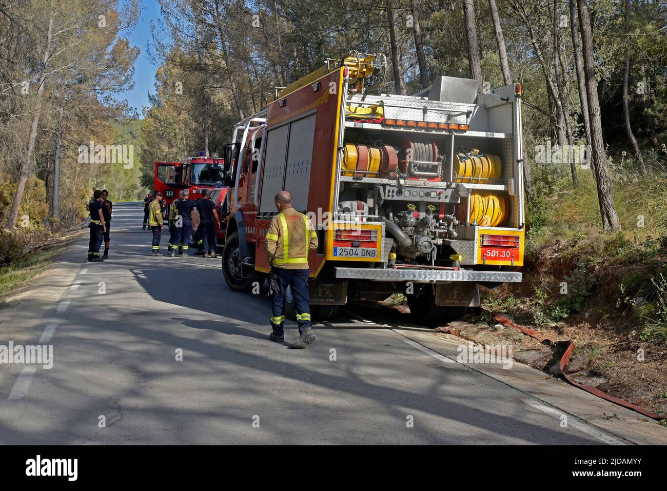 A group of firefighters from the Government of Catalonia carry out a  surveillance checkpoint in case the fire revives in the forest zone of  Olivella (Barcelona). The Firefighters of the Government of