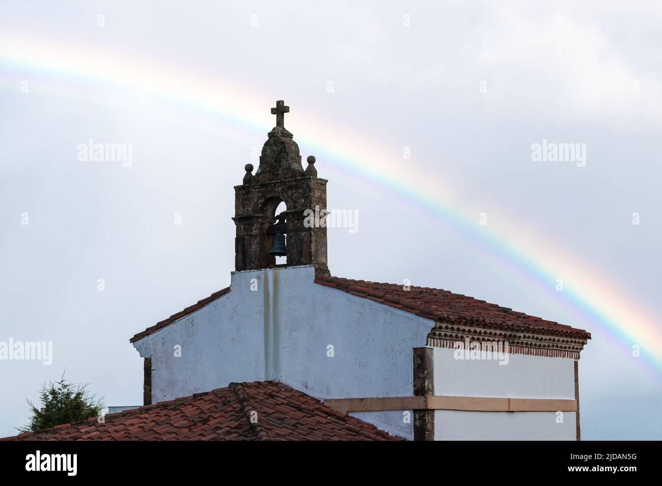 Rainbow over San Roque chapel, Lastres, Asturias,Spain. Stock Photo