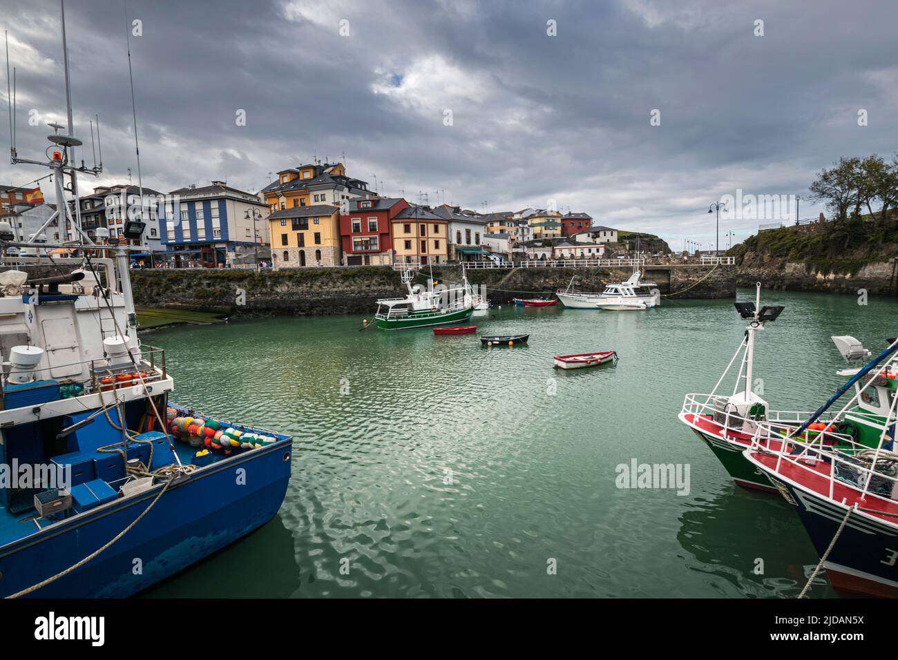 Picturesque port area of Puerto de Vega town in Asturias, Spain with beautiful blue waters and fishing boats. Stock Photo