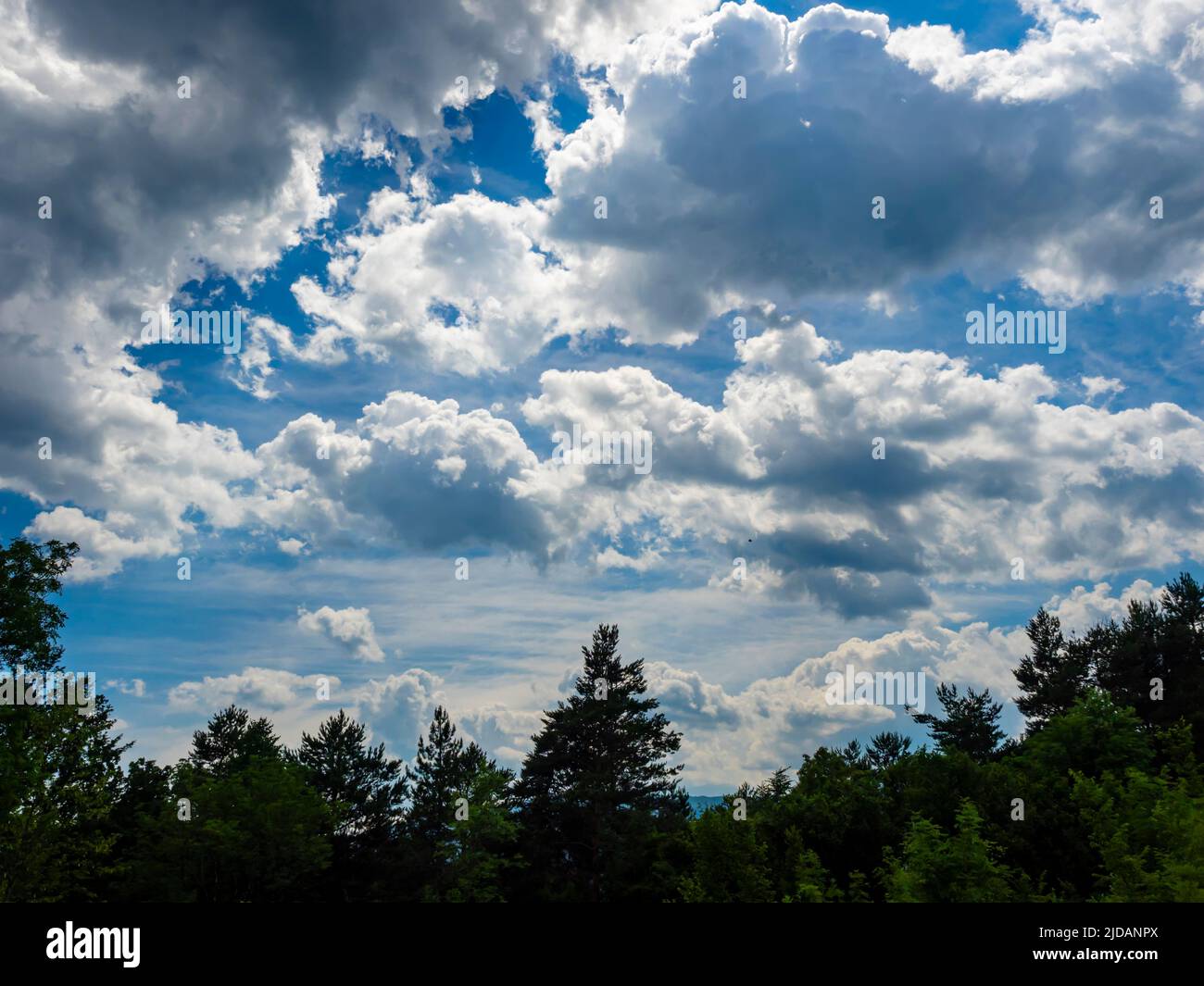 Fluffy clouds sunshine Blue sky Stock Photo