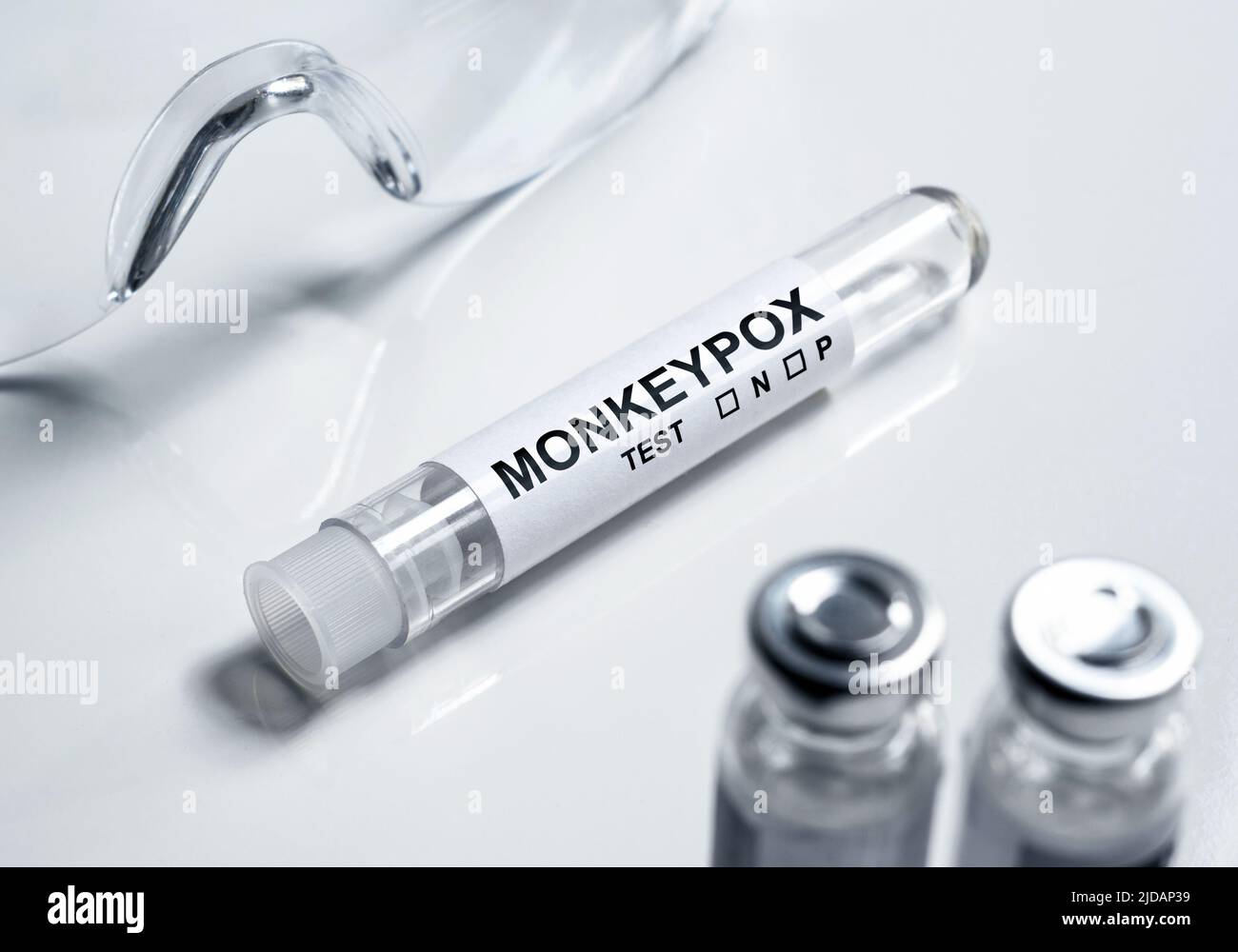 Monkey pox test tube in lab, on white medical desk. Equipment for monkeypox virus diagnosis and smallpox research. Concept of monkey pox outbreak, tes Stock Photo