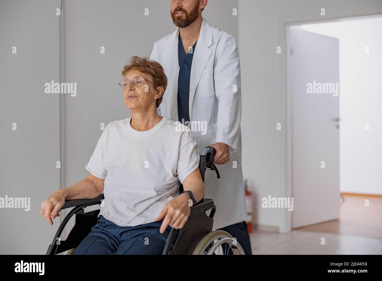 Close up of professional male doctor carrying female patient on