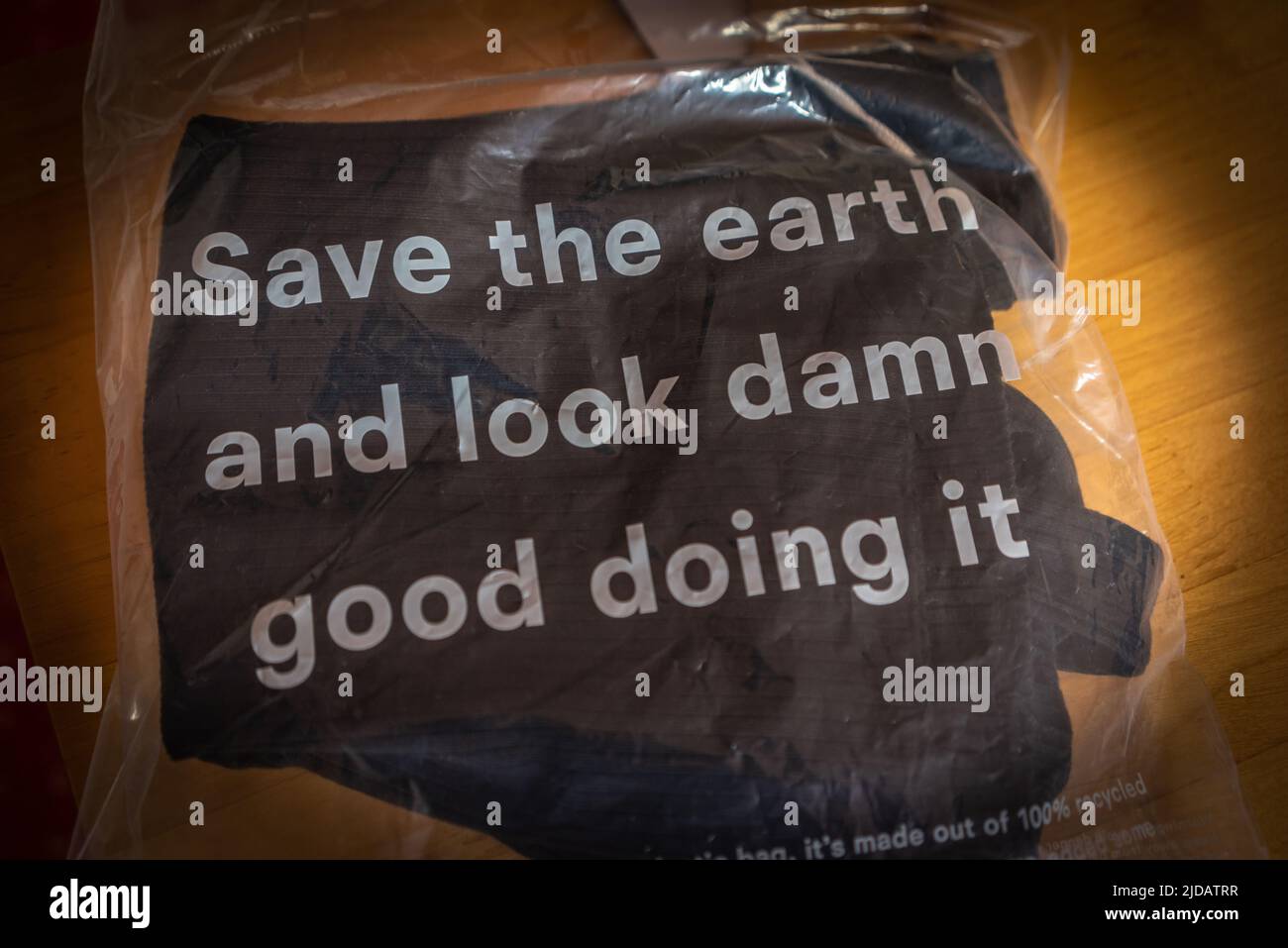 Sustainable environmentally friendly clothing made by Reformation - an American fashion retailer, 'Save the earth and look damn good doing it' packaging Stock Photo