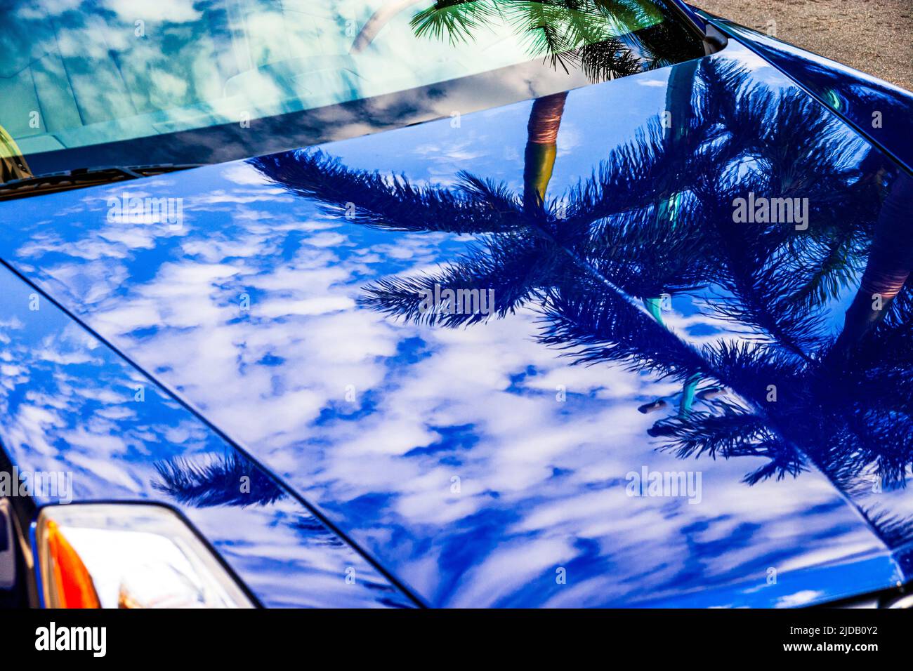 Classic car hood and blue sky and white clouds hires stock photography