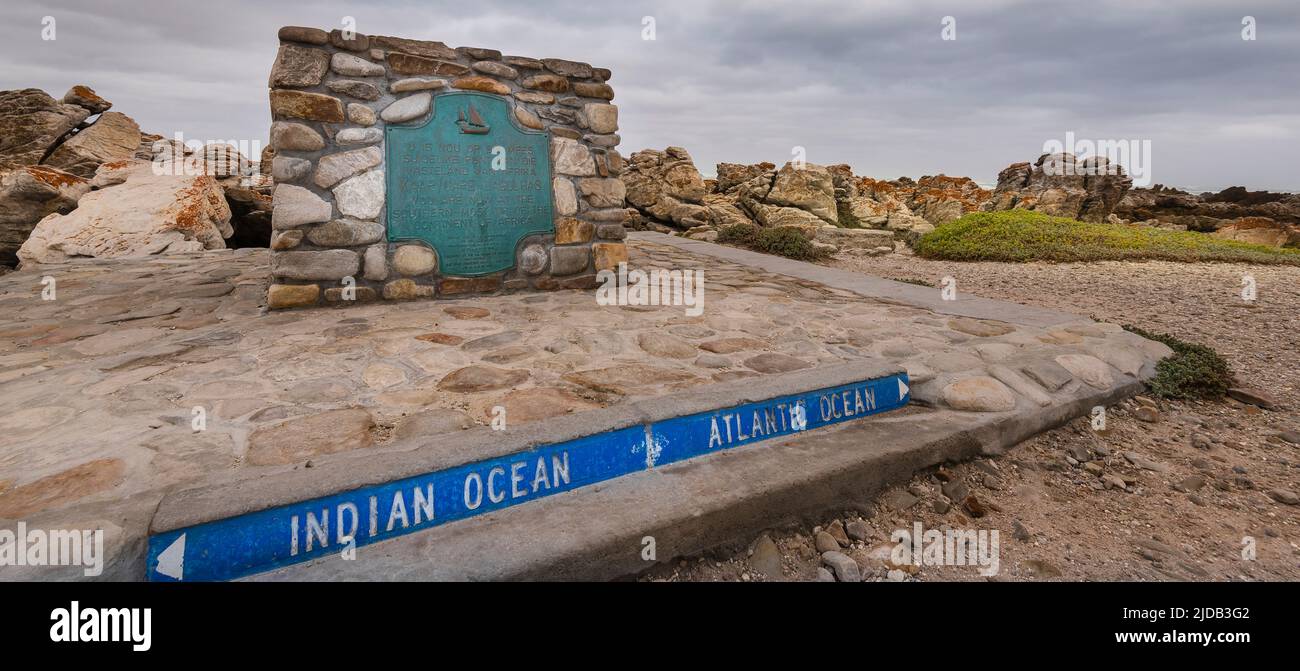 Sign and metal plaque indicating the Southern Most Point of the Continent of Africa and the maritime border of the Indian and Atlantic Oceans at Ca... Stock Photo