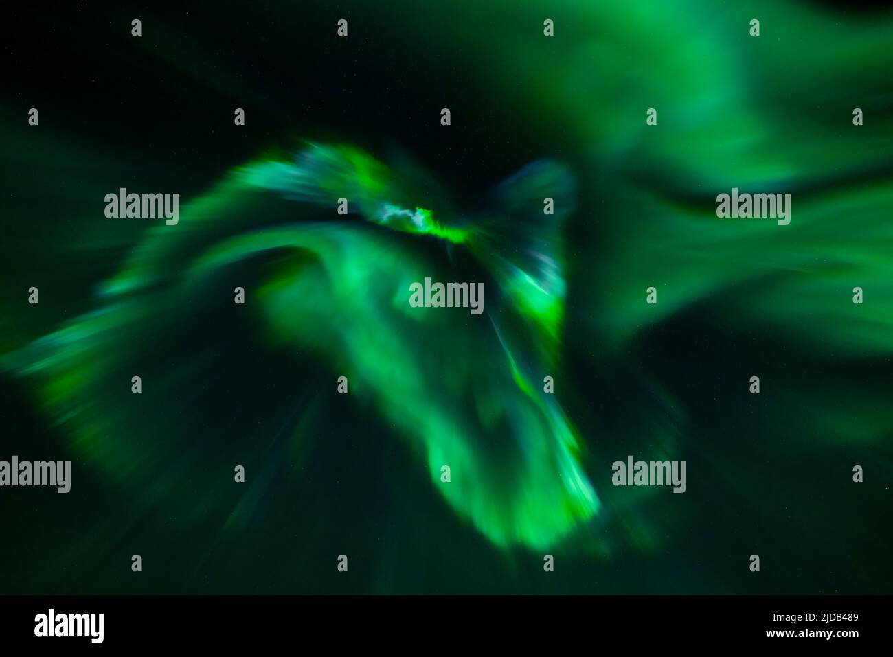 Glowing green Northern Lights (Aurora borealis) in a vast night sky ...
