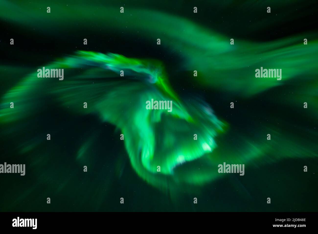 Glowing green Northern Lights (Aurora borealis) in a vast sky at night ...