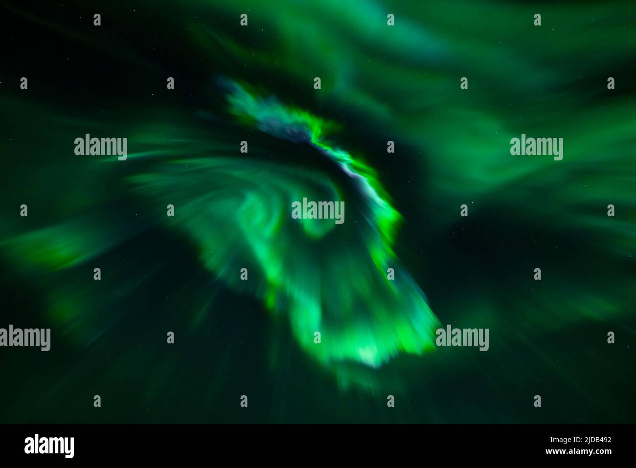 Glowing green Northern Lights (Aurora borealis) in a vast night sky ...