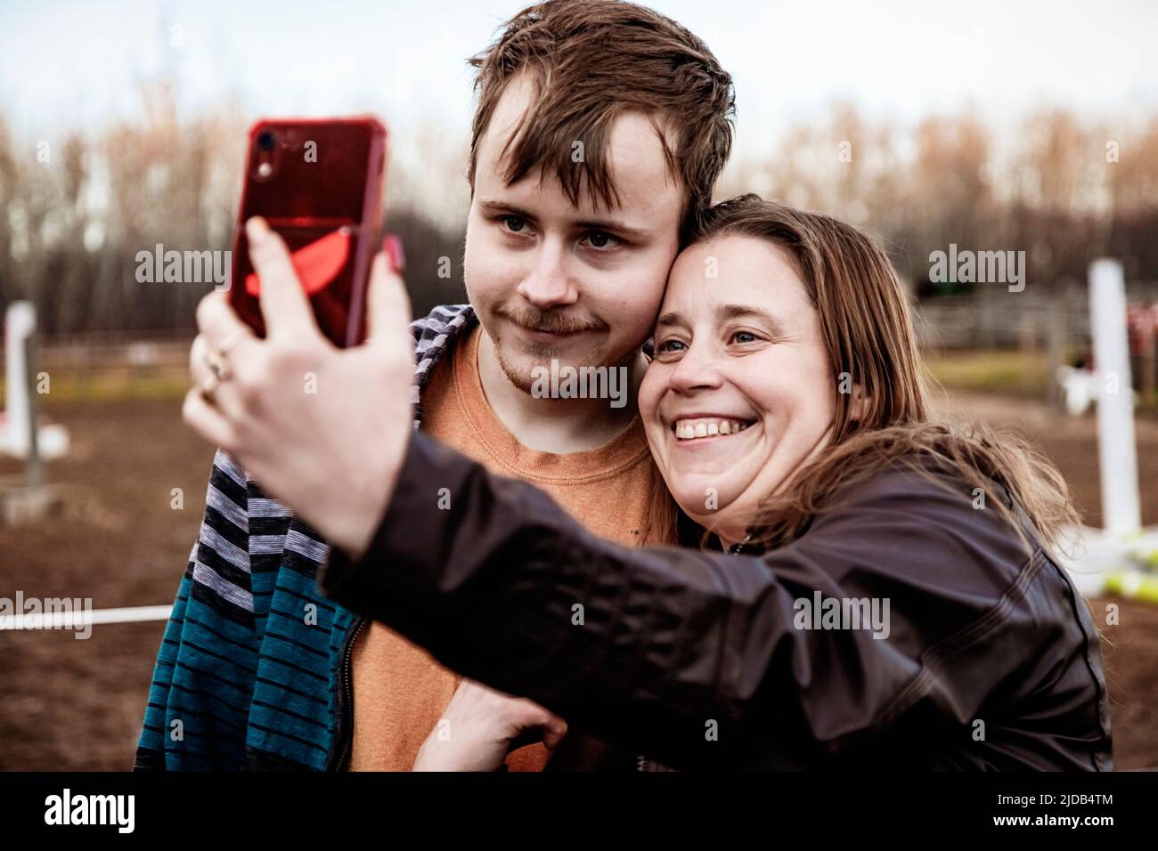 A mom with epilepsy taking a self-portrait with her son who has Aspberger Syndrome at an equine centre; Westlock, Alberta, Canada Stock Photo