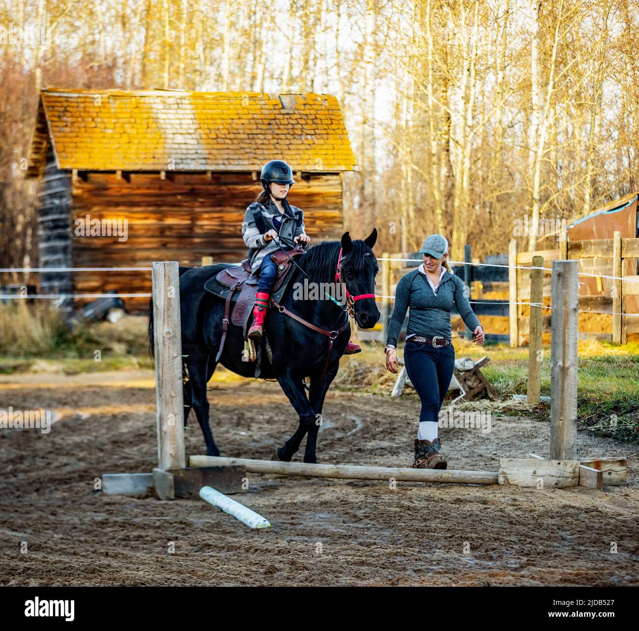 A young girl with Cerebral Palsy and her trainer working with a horse
